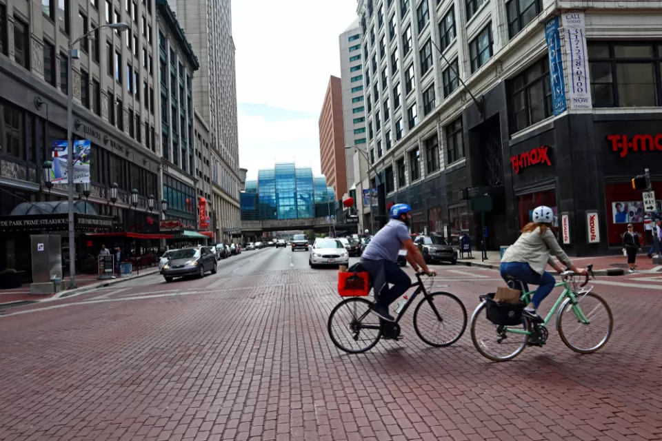 Two bicyclists on a street in downtown Indianapolis, Indiana